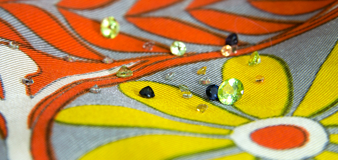 Peridot, blue sapphire, and fancy yellow and green sapphire on a printed scarf