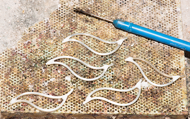 a soldering pad with silver parts and a solder pick