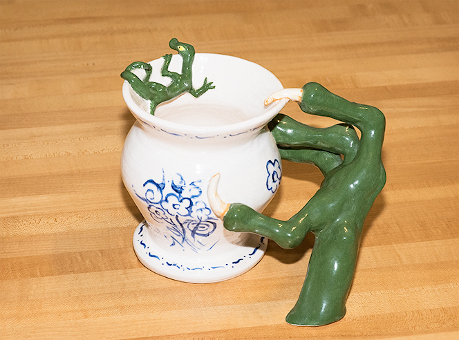 Vase with a claw reaching for a lizard