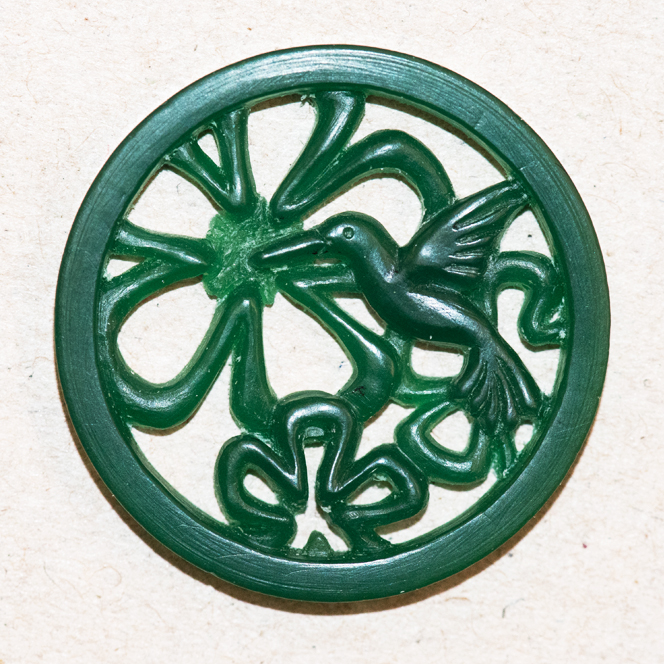 A wax carving for casting showing progress on a hummingbird necklace to be cast in silver.