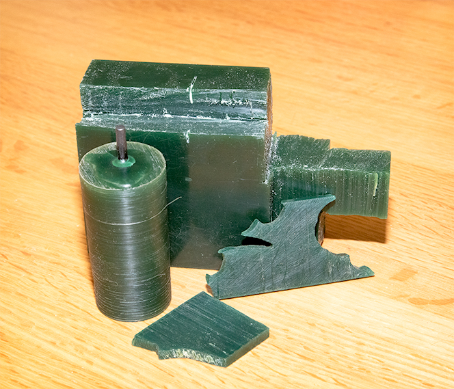 Various types of carving wax for casting showing a block, a tube, and two sheets.