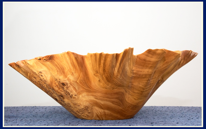 side view of elm burl wooden bowl with ruffled edge