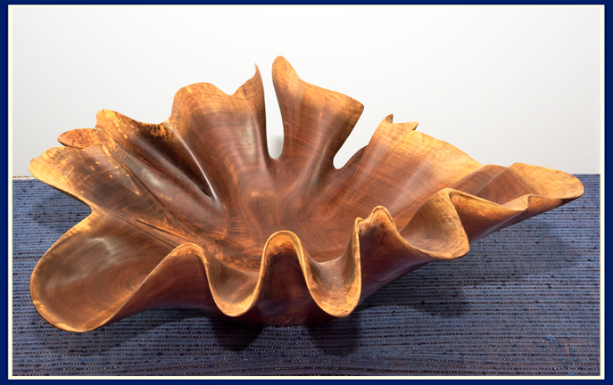 Black walnut wooden bowl with a flowing wavy edge