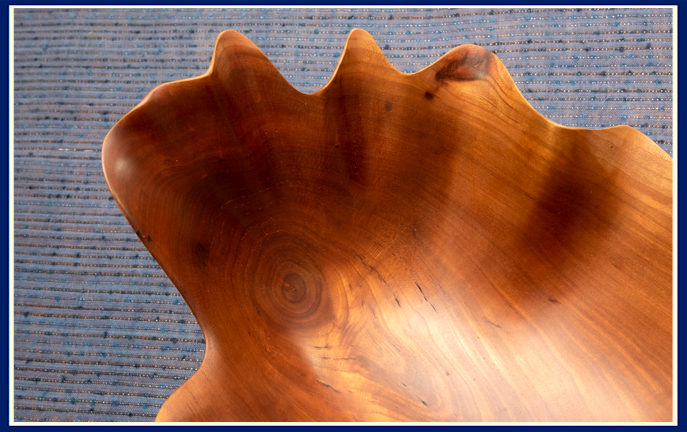 close up burl in artisan bowl carved in cherry wood