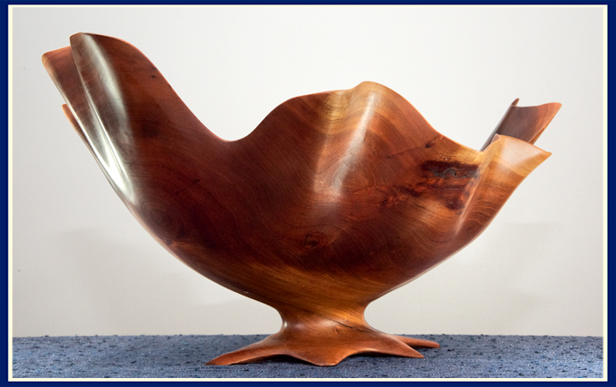 side view of an artisan hand crafted wooden bowl in cherry