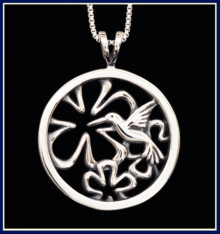 Sterling silver necklace with a humming bird and flowers in a circle