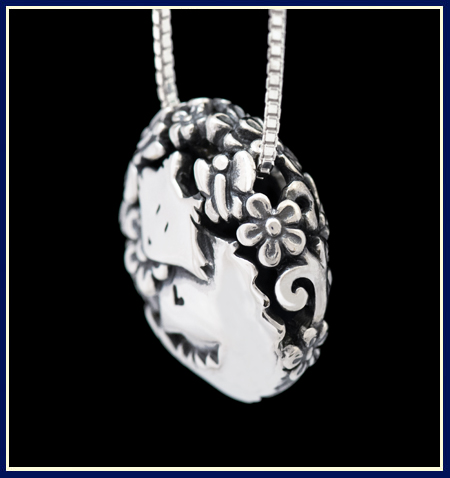 Filigree cat necklace in sterling silver side view with flowers