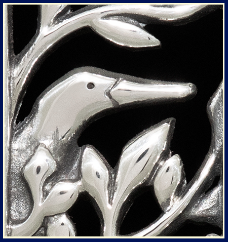 Detail of a necklace with a green heron cast in sterling silver