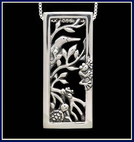 Handmade sterling silver pendant with animals hiding in mangroves