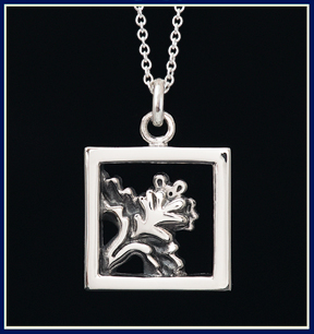 Silver pendant with mouse peaking out from behind an iris flower